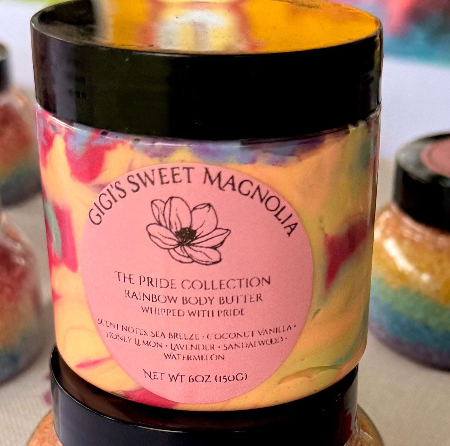 Pride Collection Body Butter - labeled jar with rainbow sugar scrubs at market